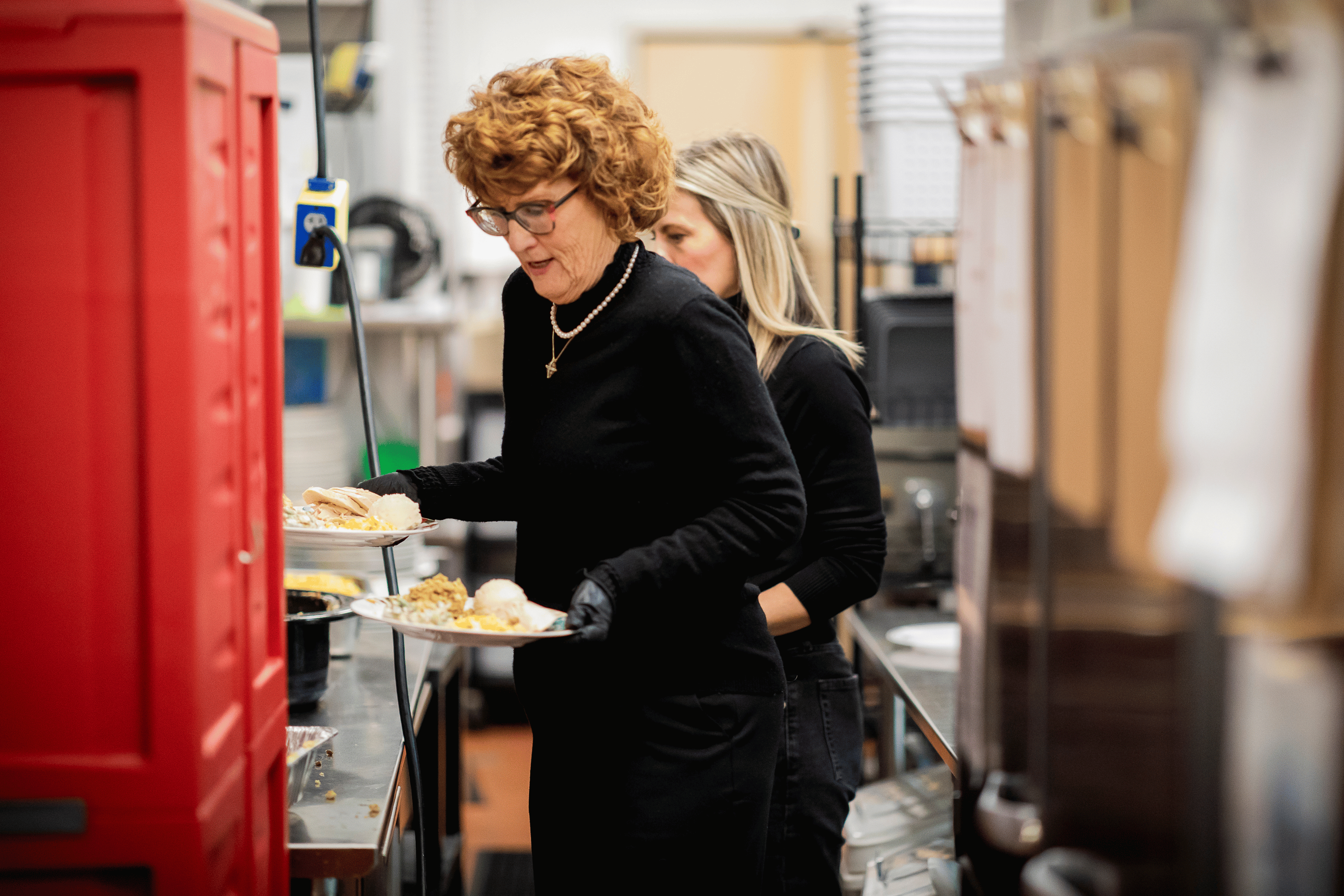 June Serving Food at Thanksgiving Feast