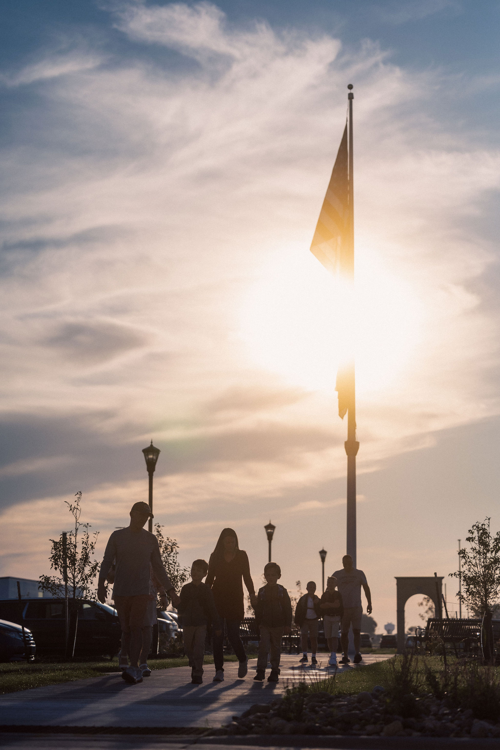 family walking in against sunrise