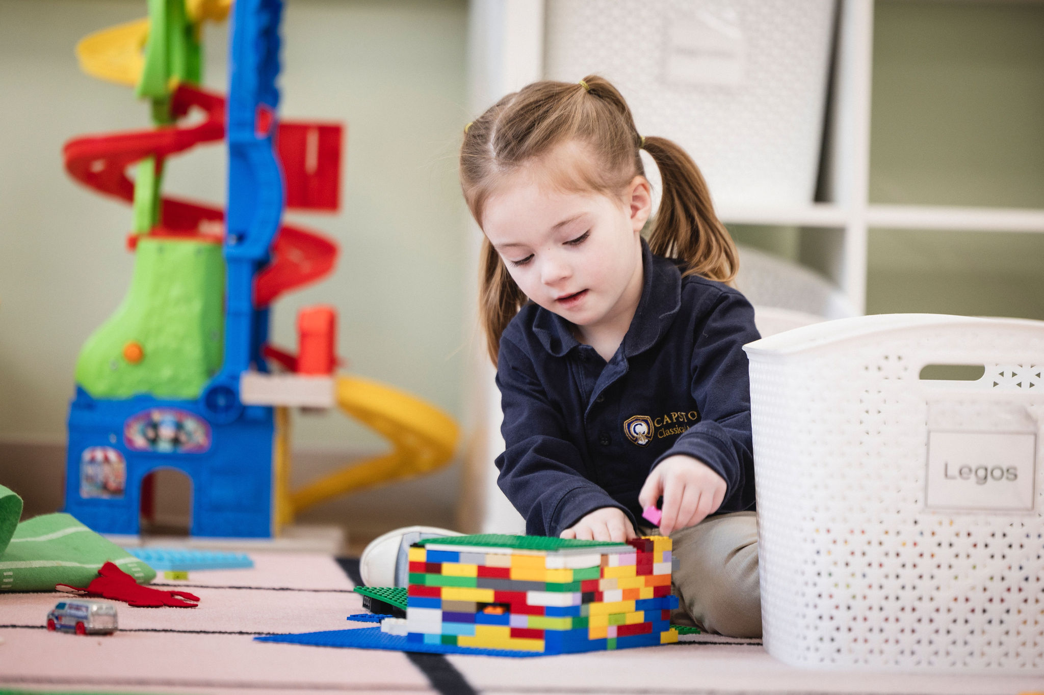 prek girl playing with legos