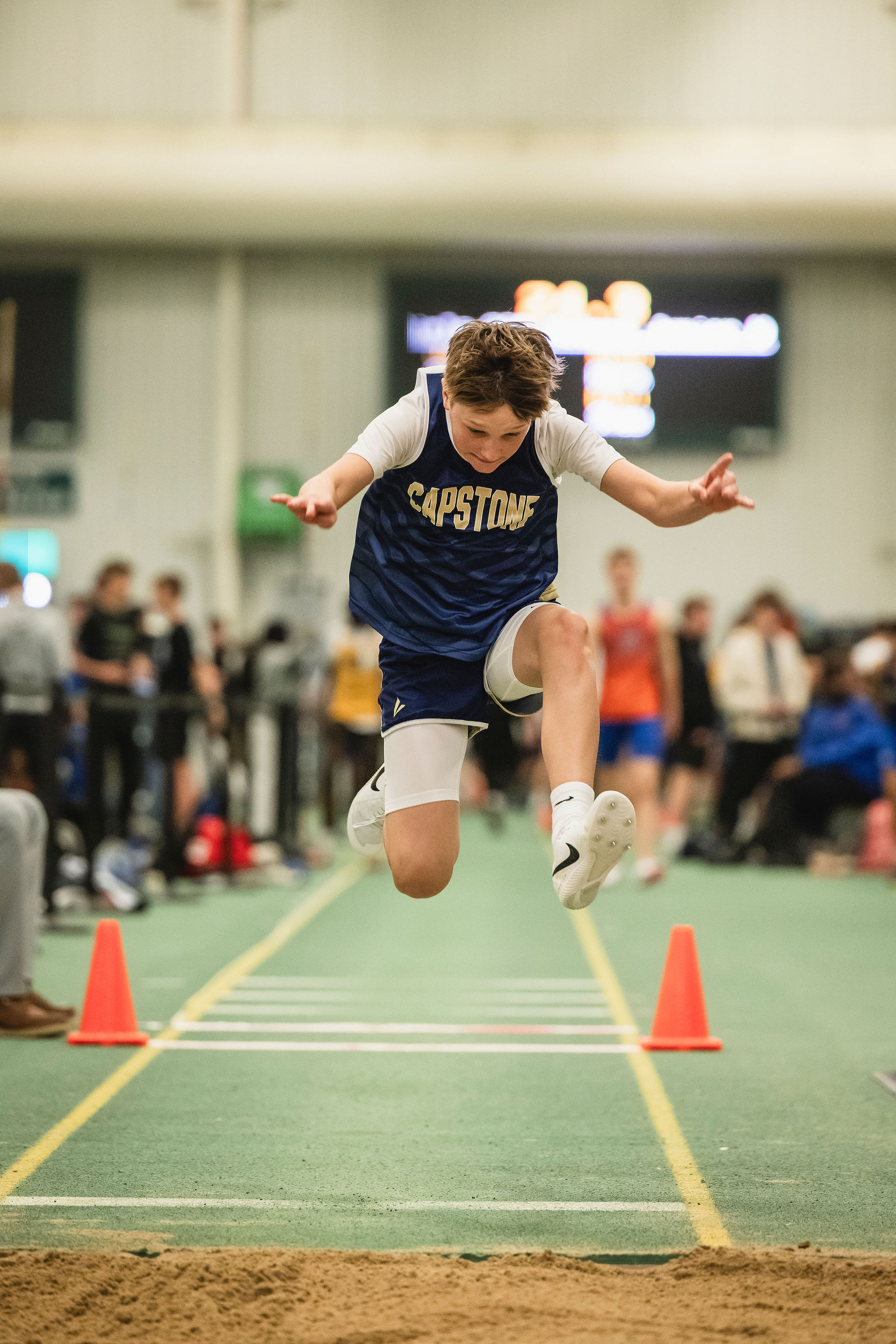 boy doing long jump