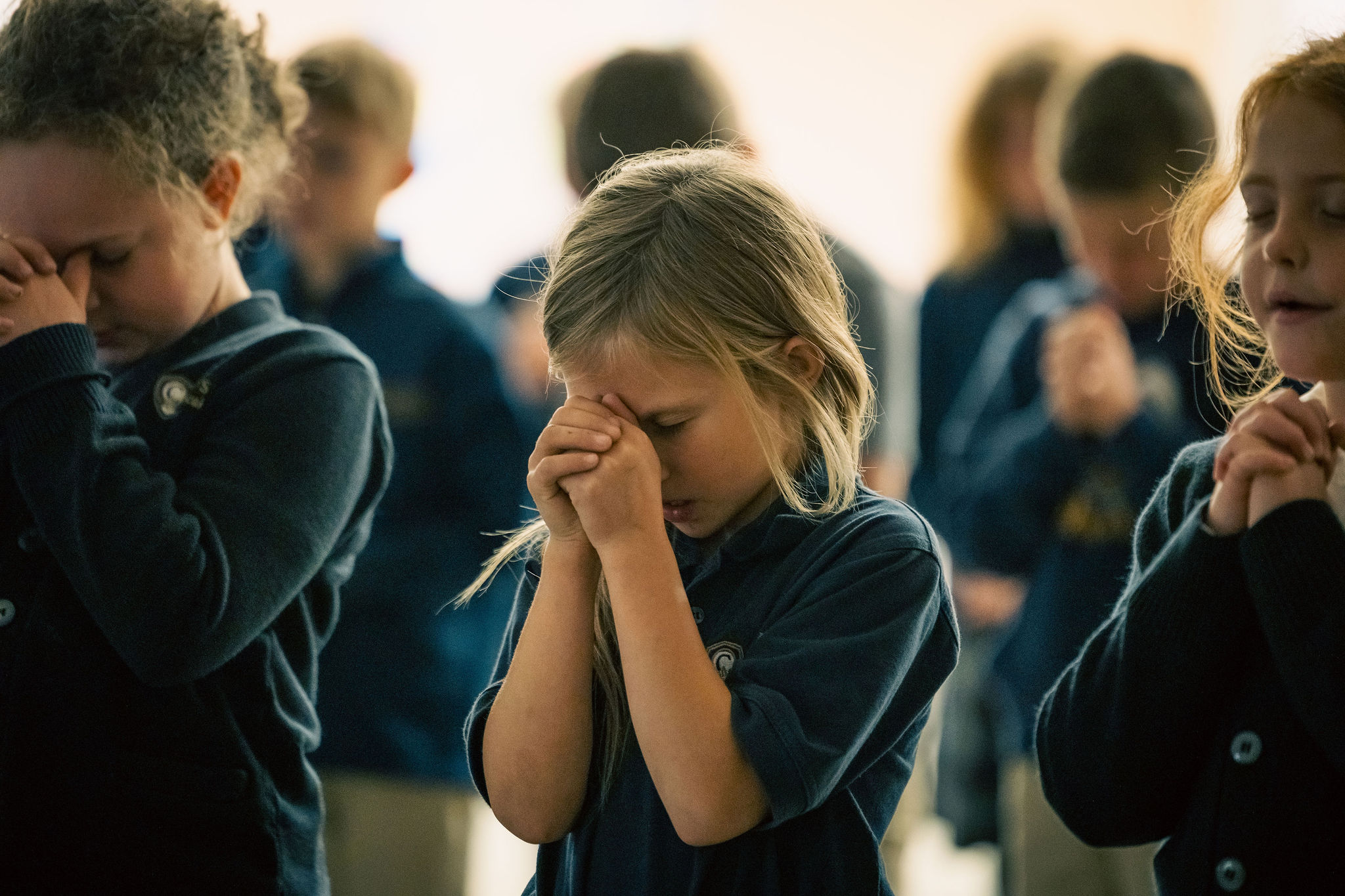 lower school girl in prayer