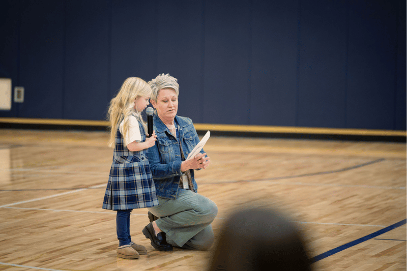 Dean Helping Young Girl Recite