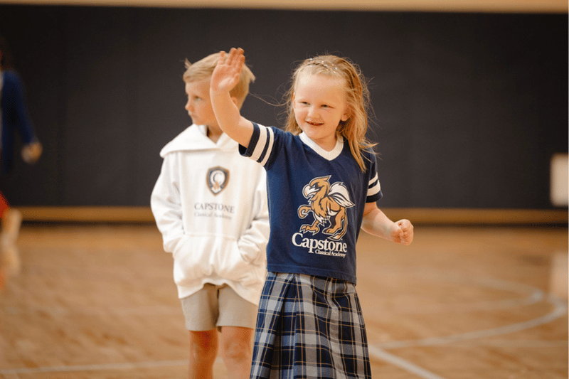 Girl waving in Gryphon Gear