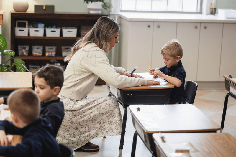 Teacher Helping Kindergarten Boy