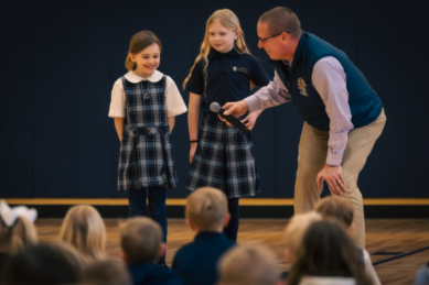 Two students and teacher with microphone