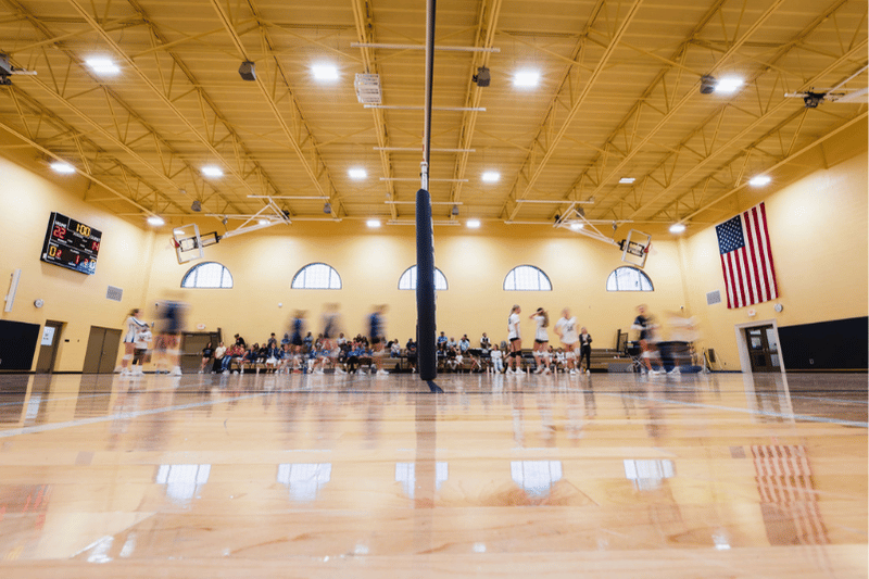 Wide Shot of Gym with Blurred Volleyball Players
