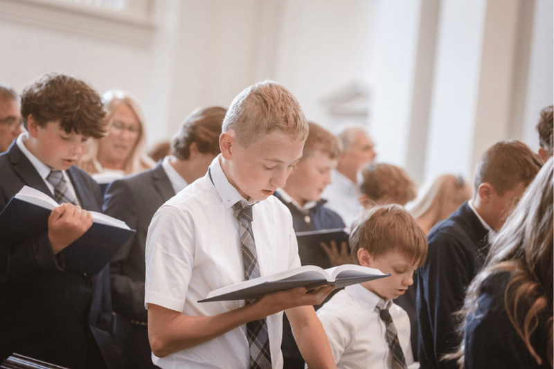 Young Man Singing in Chapel