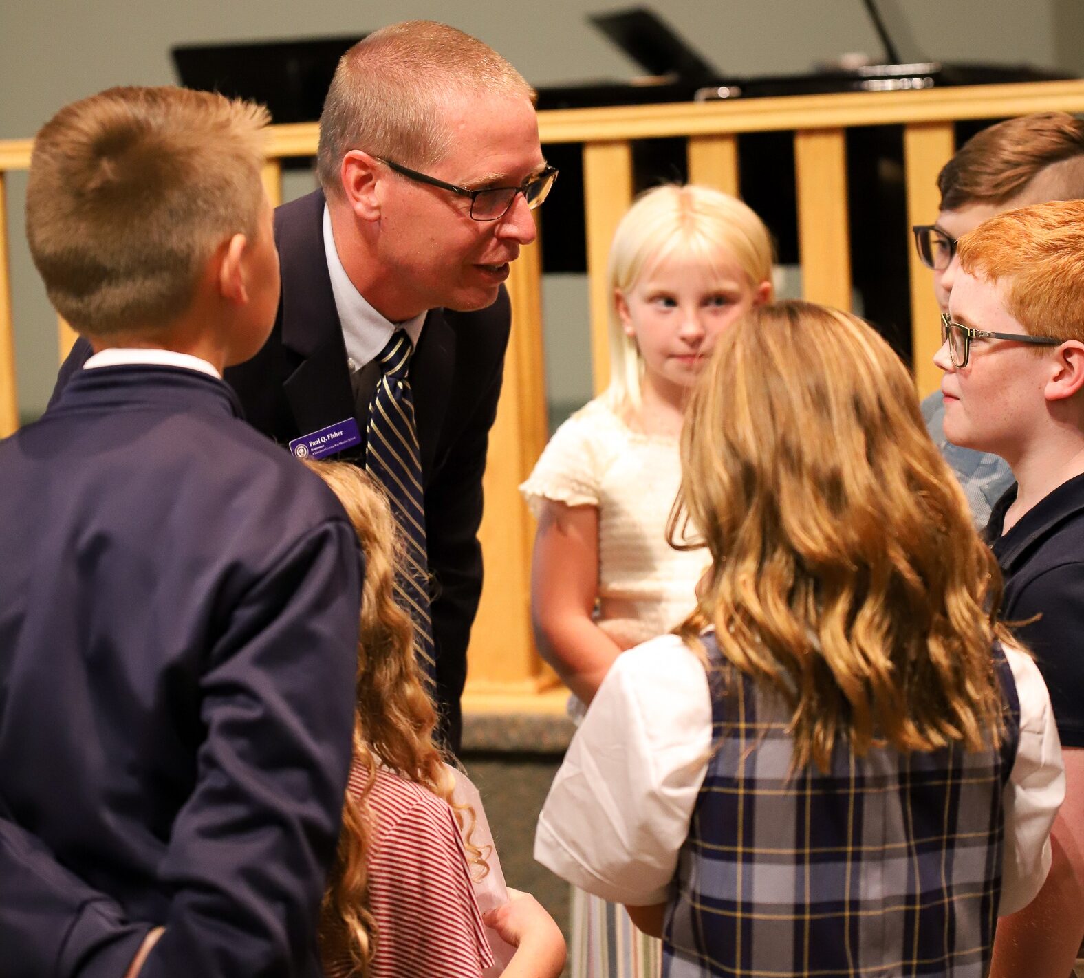 Headmaster Paul Fisher huddled with students