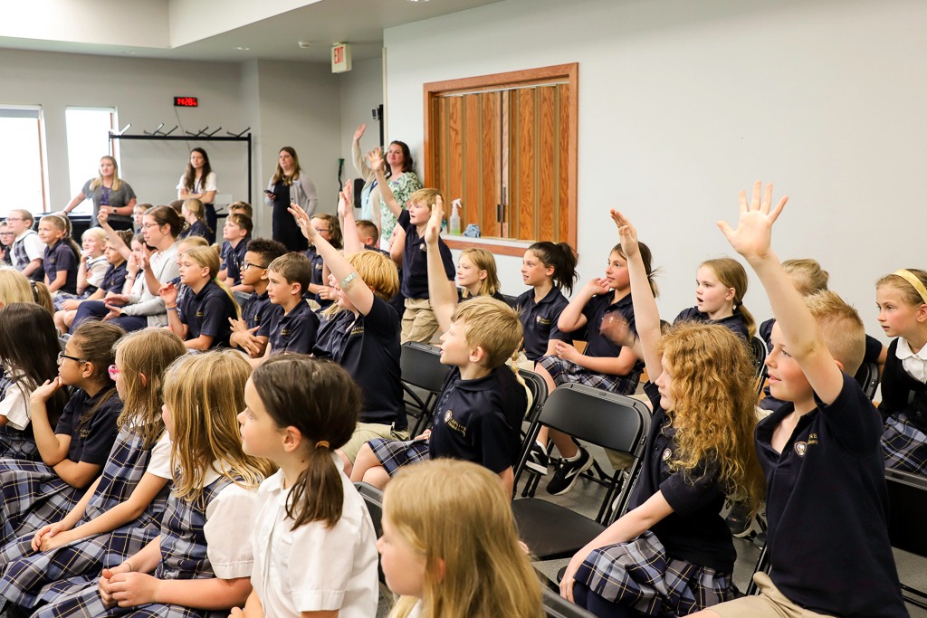 Students eagerly raising their hands