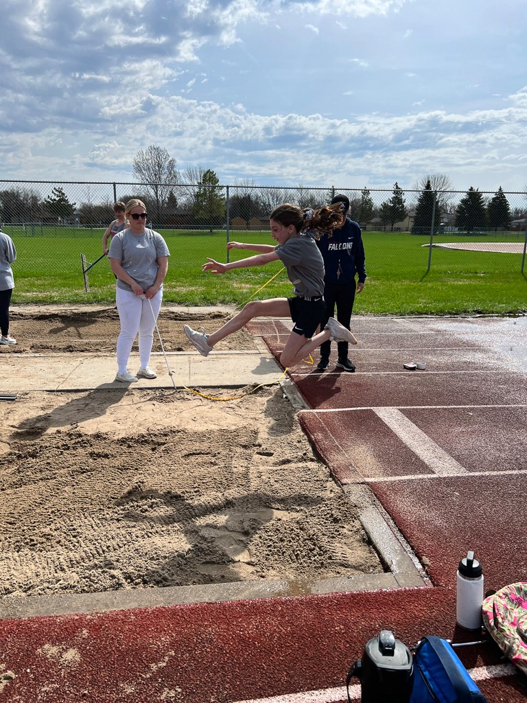 Student jumping on track