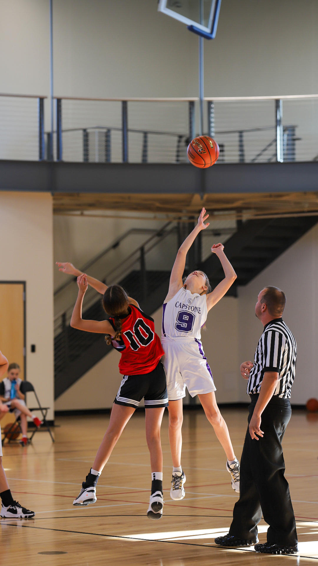 Student winning opening toss at basketball game