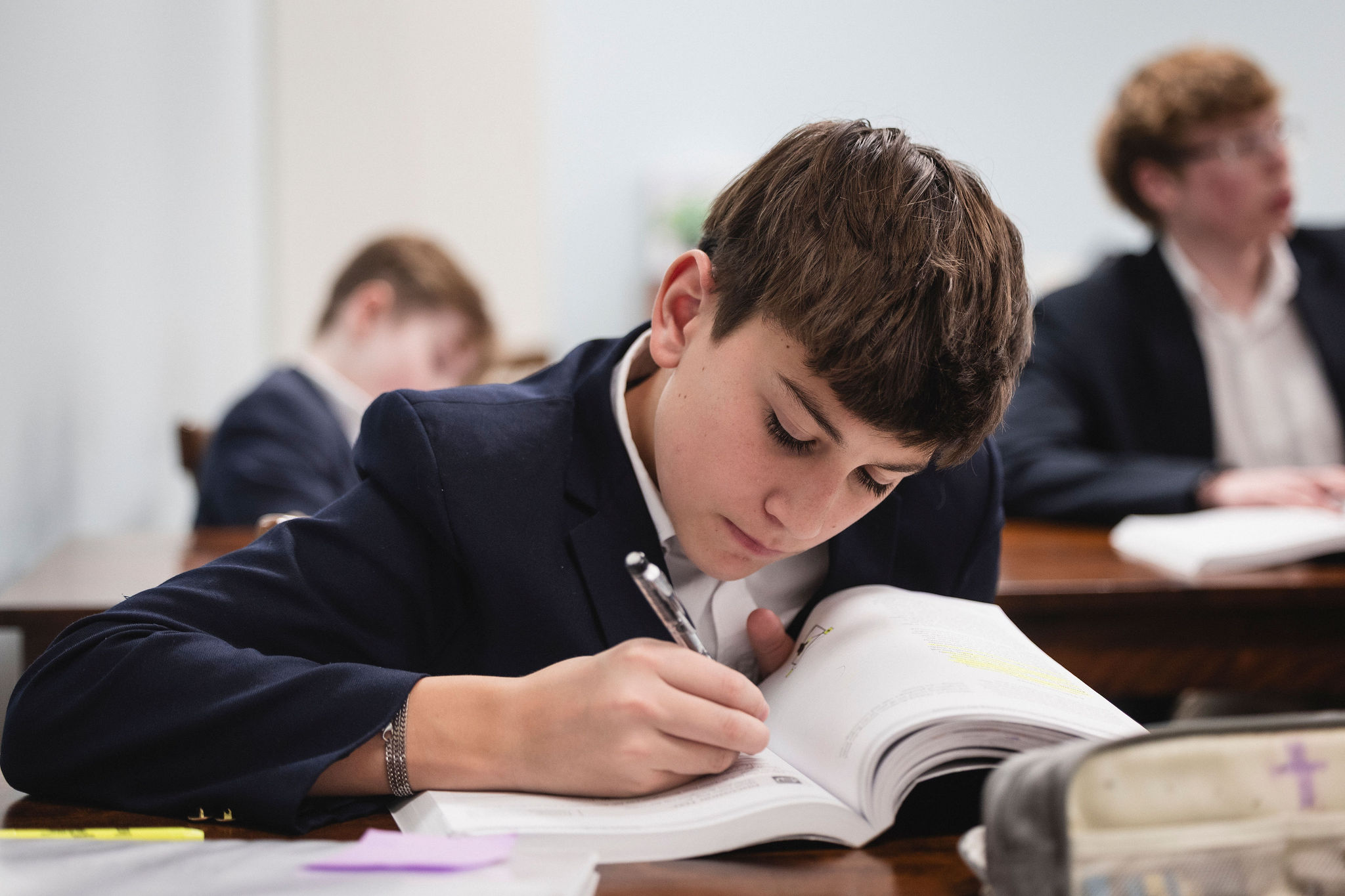 boy writing in book